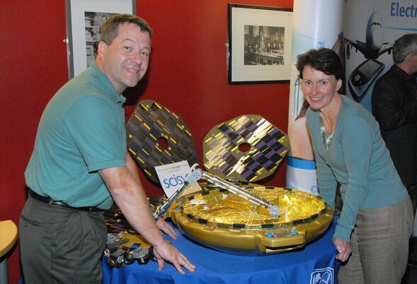 Nicholas Patrick, engineer and NASA astronaut, standing alongside Helen Sharman, chemist and astronaut with a scale model of the Beagle 2 lander between them.