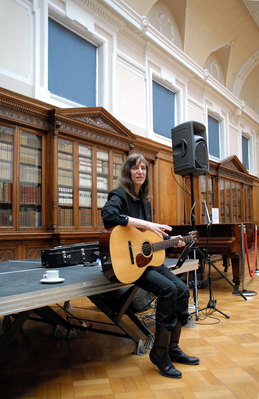 Singer-songwriter and poet Patti Smith is seated between songs in Glasgow's Mitchell Library